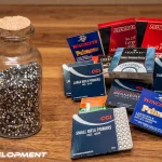 news packs of different types of reloading primers next to a bottle of fired primers