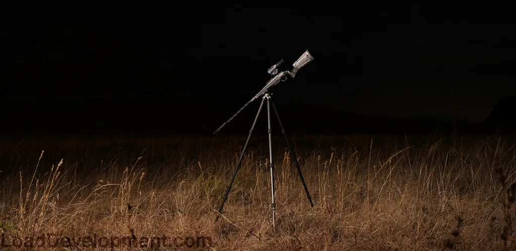 Thermal hunting rifle on tripod with thermal scope mounted on top for hog hunting.