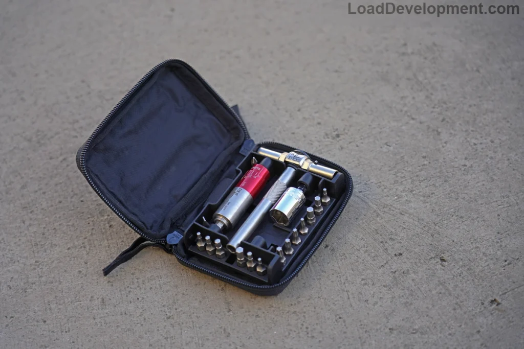 A fix it sticks all in one kit lying on a concrete surface outside. The perfect gun torque wrench for travel.